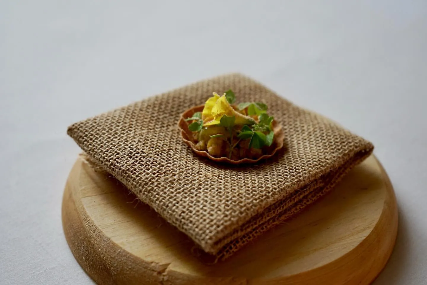 Loquat tartelette on hessian, a canape from a private chef tasting menu
